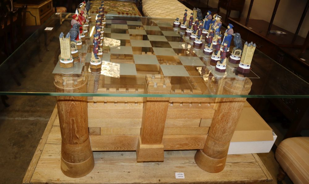 A Heritage Tables jigsaw chess table, modelled on Bodiam Castle with chequer glass top and a set of composition chess pieces, table W.1
